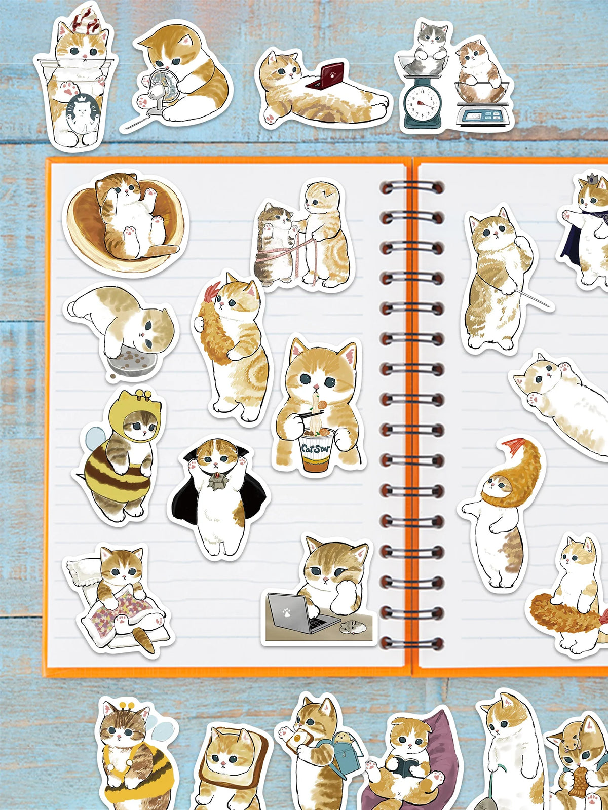 A collection of various cat stickers featuring different poses and expressions on a white lined sheet.
