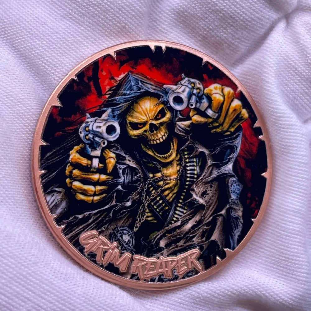 A copper challenge coin featuring a grim reaper design with a skull and guns.