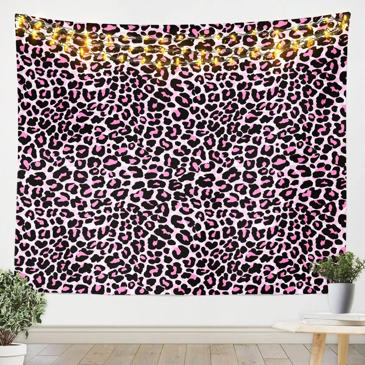 A vibrant leopard print tapestry wall hanging featuring black and pink wild animal pattern decor.