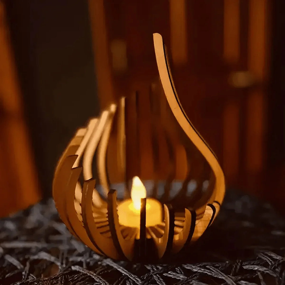 Handcrafted wooden lotus candle holder glowing with a flame on a dark textured surface.
