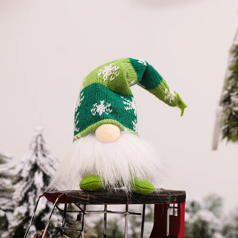 A green knitted gnome decoration with a white beard and yellow nose sitting on a rustic surface.