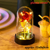 An LED galaxy rose artificial flower displayed inside a glass dome on a dark surface.