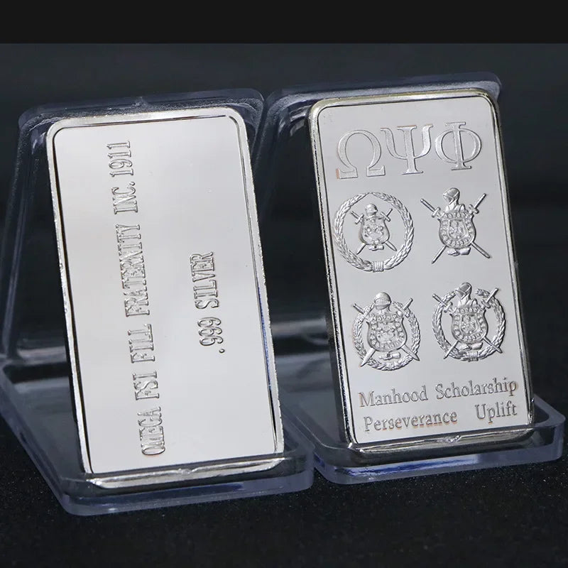 A silver bullion bar replica featuring Greek letters and a scholarship inscription on a clear plastic holder.