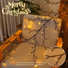 LED willow vine lights draped across a beige cushion and wooden furniture for holiday decor