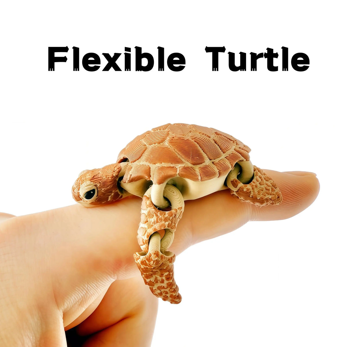 A hand is holding a flexible turtle figurine decoration with textured skin and visible joints.