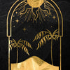 Gold-framed artwork featuring a sun, stars, and palm trees against a dark background.