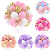 A collection of pink, white, and gold balloons with metallic pearl accents and confetti for party decor.