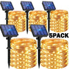 A pack of five solar powered fairy lights in a cylindrical shape with warm yellow illumination.