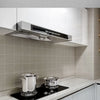 Modern kitchen wall featuring a stainless steel range hood above a countertop and glass shower area.
