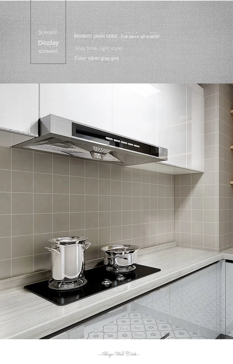 Modern kitchen wall featuring a stainless steel range hood above a countertop and glass shower area.