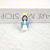 A small resin statue of the Virgin Mary with a yellow halo and blue and white robes.
