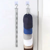 A multilayer hat organizer rack with various colored hats hanging on a closet door.