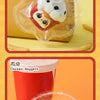 A clear plastic ice bucket filled with a white and black patterned ice cube collectible toy.