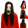 A realistic latex horror mask with long black hair wearing a red shirt.