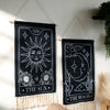 Black sun and moon boho wall tapestry featuring celestial designs on a dark background
