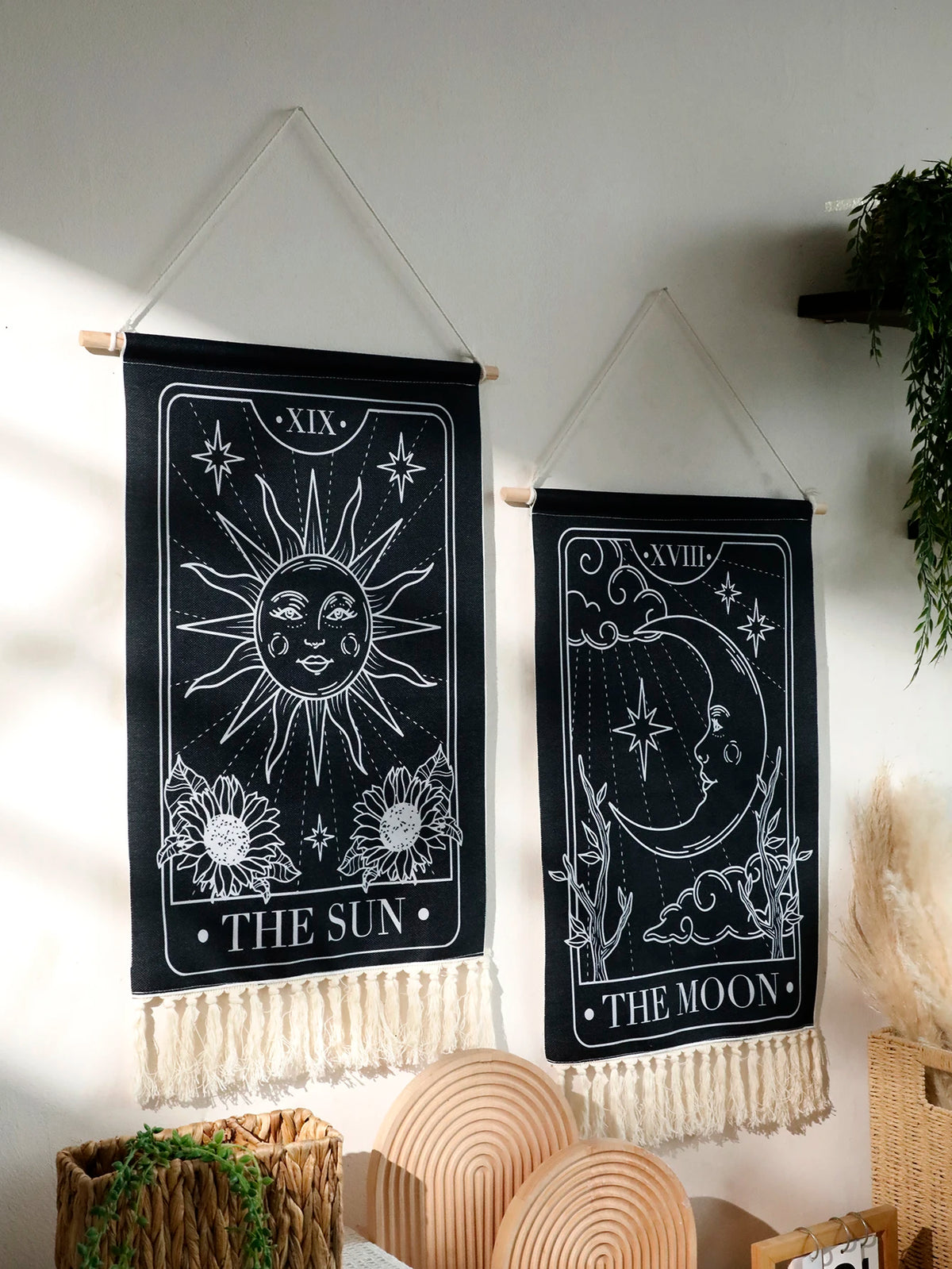 Black sun and moon boho wall tapestry featuring celestial designs on a dark background