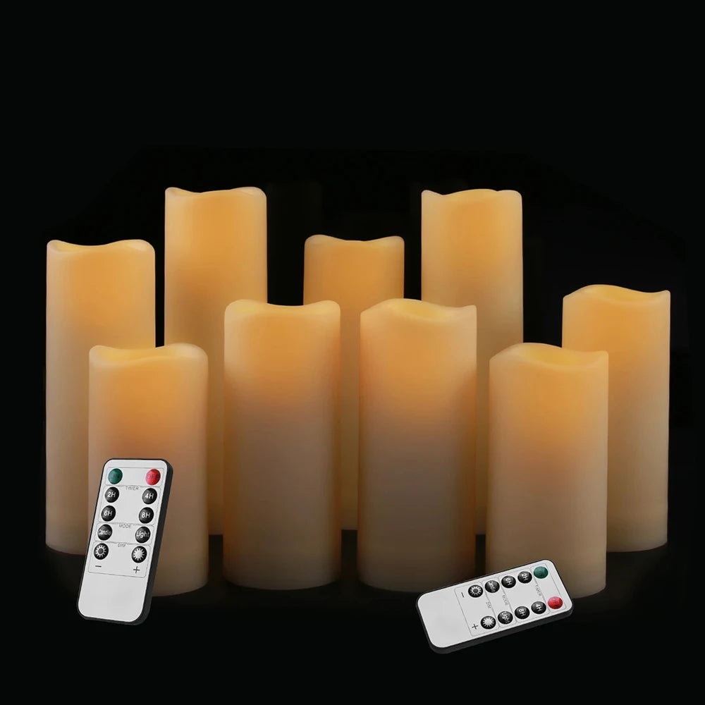 A set of four glowing amber LED candles and two remote controls are displayed against a black background.