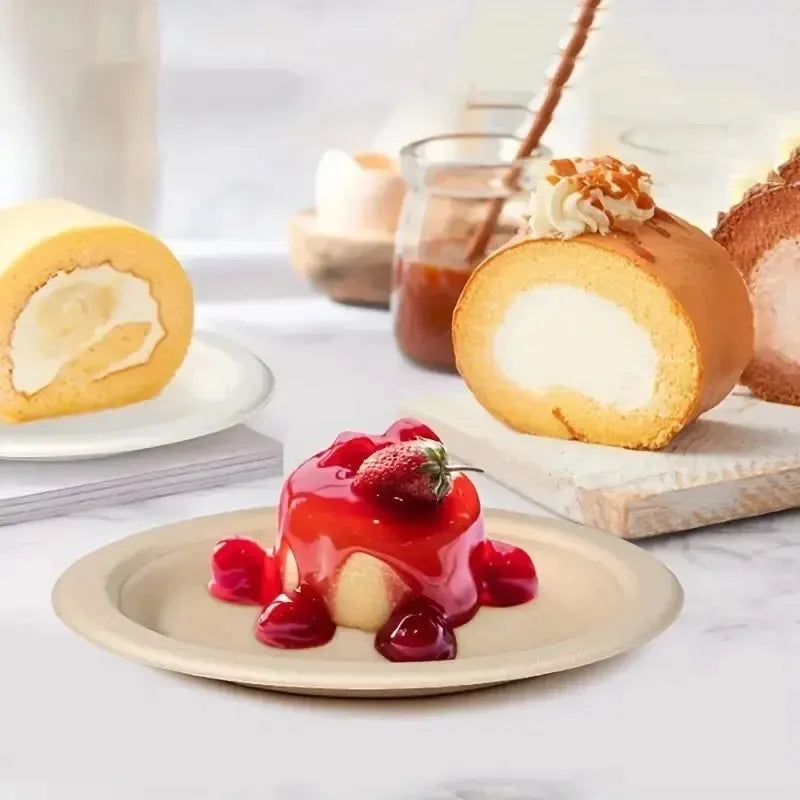 A slice of cake with cream is served on a disposable paper plate with fresh strawberries and sauce.
