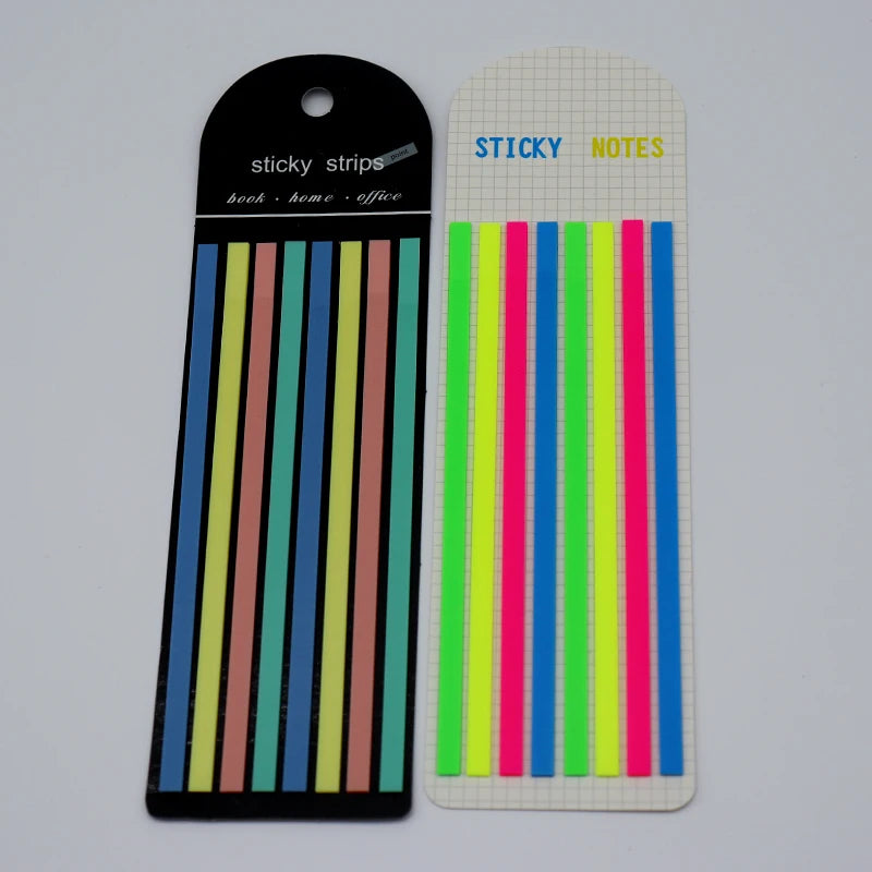 A set of transparent sticky notes and index tabs in various bright colors, packaged in a black and white grid.