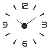 A white clock face with black hands showing 12 o'clock, featuring a modern acrylic design.
