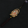 A wooden Our Lady of Guadalupe pendant charm with a gold-colored frame and dark cord.