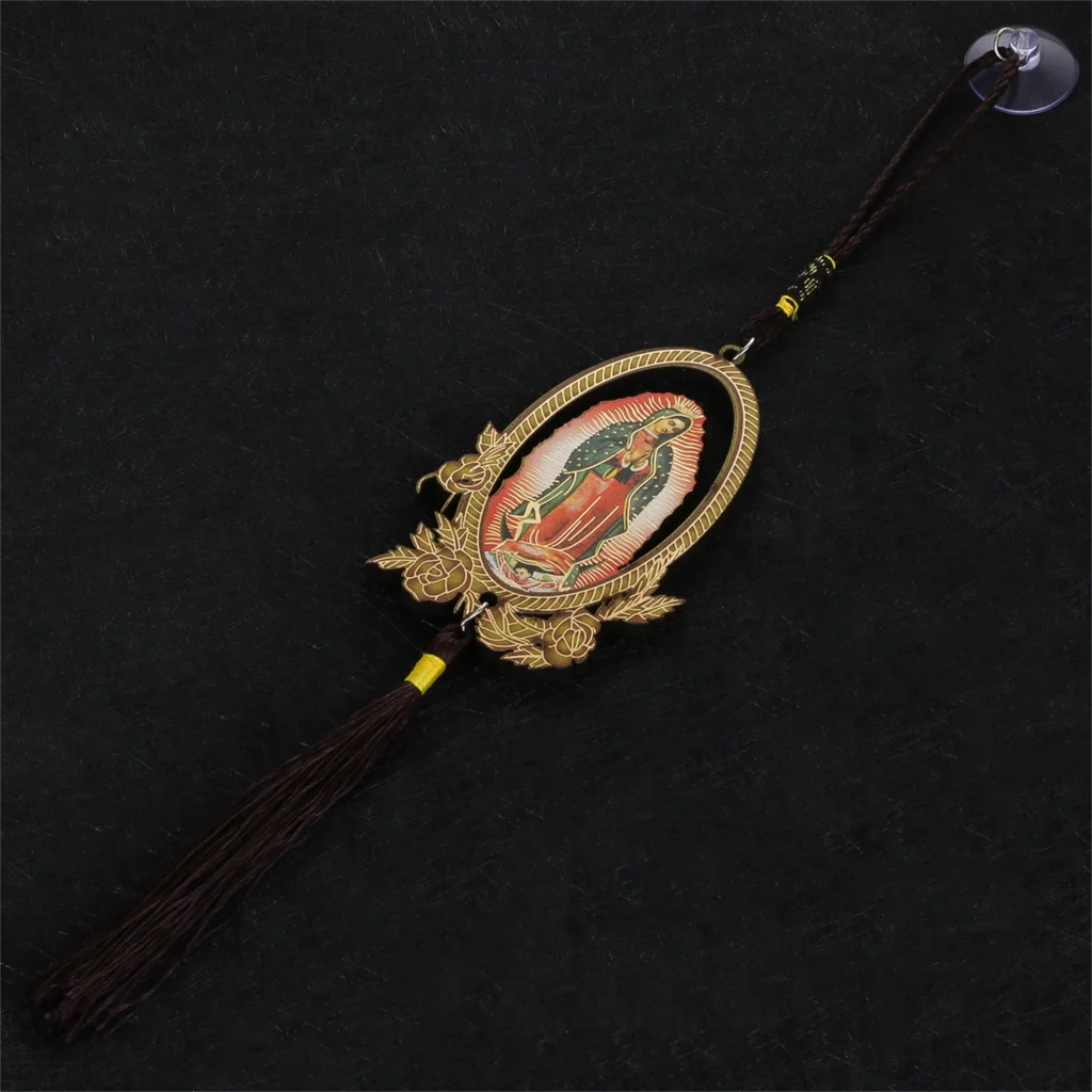A wooden Our Lady of Guadalupe pendant charm with a gold-colored frame and dark cord.