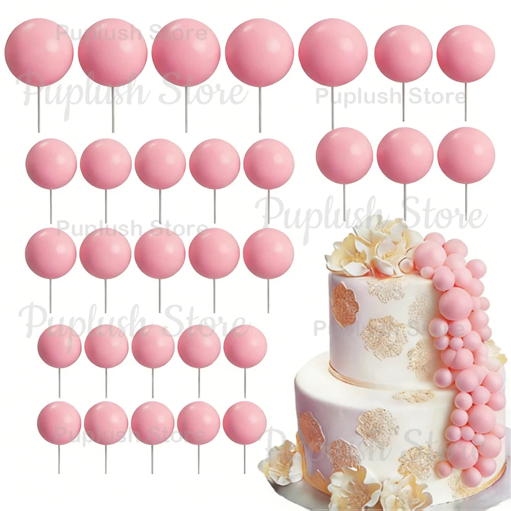 A set of pink foam cake toppers, including various sizes and shapes, arranged for decoration.