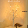 A 60cm birch tree decoration made of 24 LEDs lights displayed in a warm, indoor setting.
