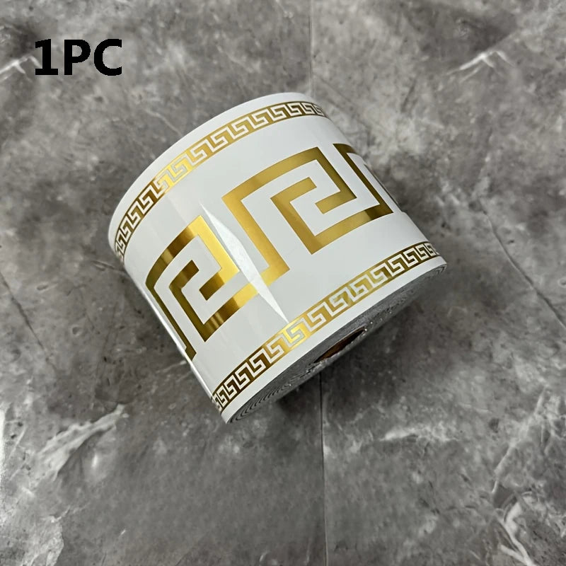 One piece of gold and white self-adhesive PVC baseboard trim with a repeating brick pattern.