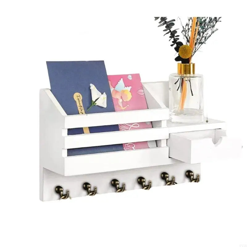 A white wall-mounted organizer featuring a drawer for mail and keys, with a glass candle in a holder.
