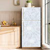 A modern stainless steel refrigerator with a light blue and gray floral pattern displayed in a kitchen setting.