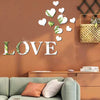 Decorative wall art featuring white and green heart shapes with a mirror finish above the word LOVE