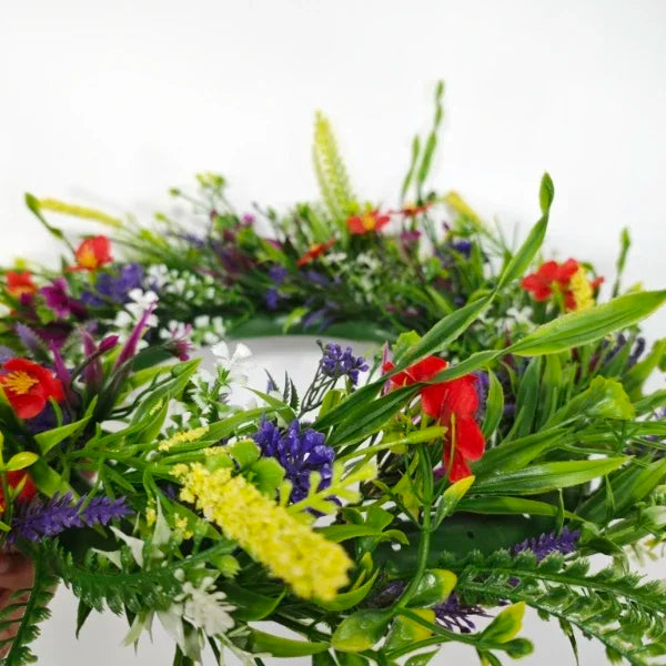 Artificial wildflower door wreath featuring colorful spring and summer flowers like red, yellow, and purple.