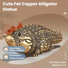 A detailed statue of a cute fat copper alligator made with craftsmanship.