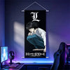 A dark poster featuring the Death Note anime character Light Yagami hanging on a wall.
