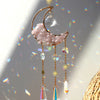 A handcrafted moon crystal suncatcher featuring a pink crescent moon and dangling prism pendants.
