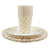 A stack of white disposable cups and a plate set with gold polka dots on a white background.