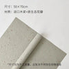 A sheet of light green decorative packaging paper with scattered dried flower petals rolled up.