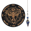 A black wooden pendulum board featuring a geometric design and an inlaid rose quartz crystal necklace on a silver chain.