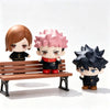 Three collectible figures of Jujutsu Kaisen characters: one with brown hair, one with pink hair, and one with black spiky hai