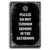A black metal tin sign with a gothic design featuring text that reads Please do not summon demons in the bathroom.