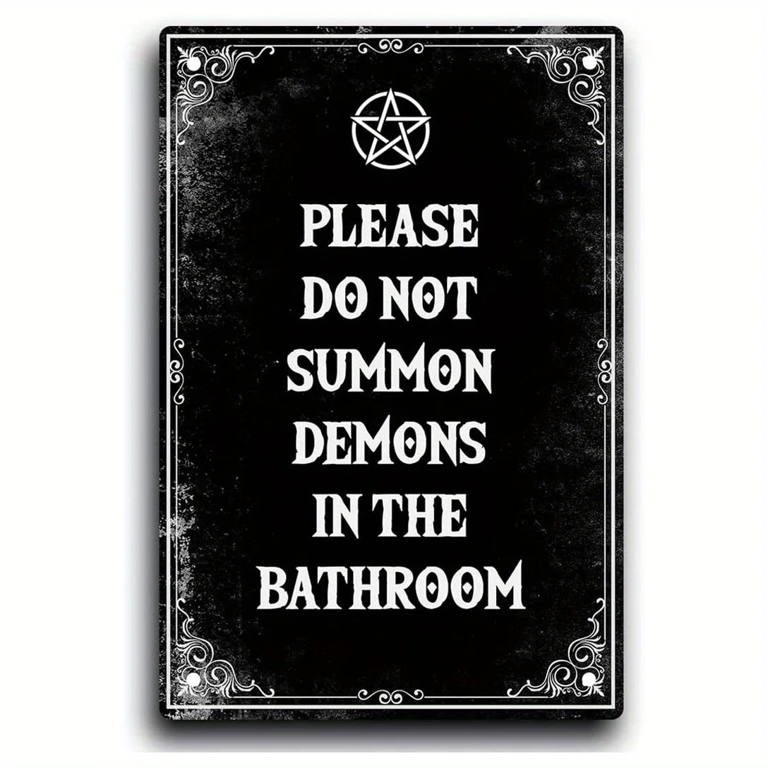 A black metal tin sign with a gothic design featuring text that reads Please do not summon demons in the bathroom.