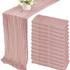 A set of ten terracotta semi-sheer cheesecloth table runners in a dusty rose color displayed on a table.