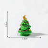 A small, green resin Christmas tree charm with a gold star topper, shown against a white background.