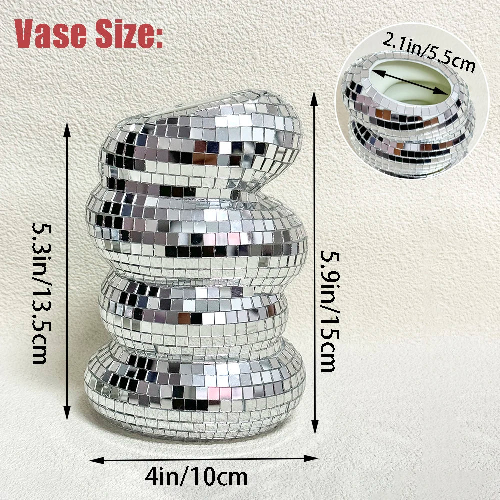 A stack of silver mirror tile disco ball vases showing various sizes and a measurement scale.