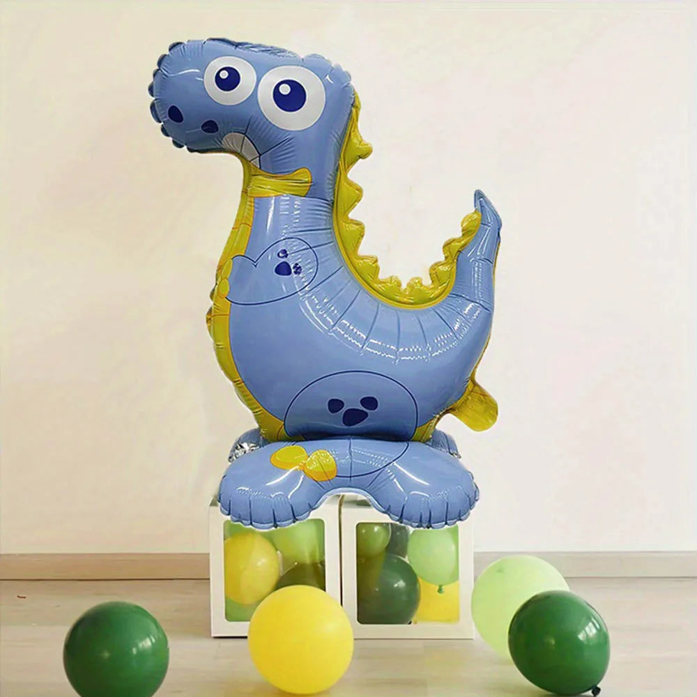 A blue foil balloon shaped like a dinosaur standing on a white box with yellow and green balloons.