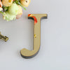 A gold letter mirror wall decal set featuring a large, three-dimensional capital letter U.