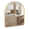 An arched full-length wall mirror with a matte black frame reflecting a modern kitchen interior.