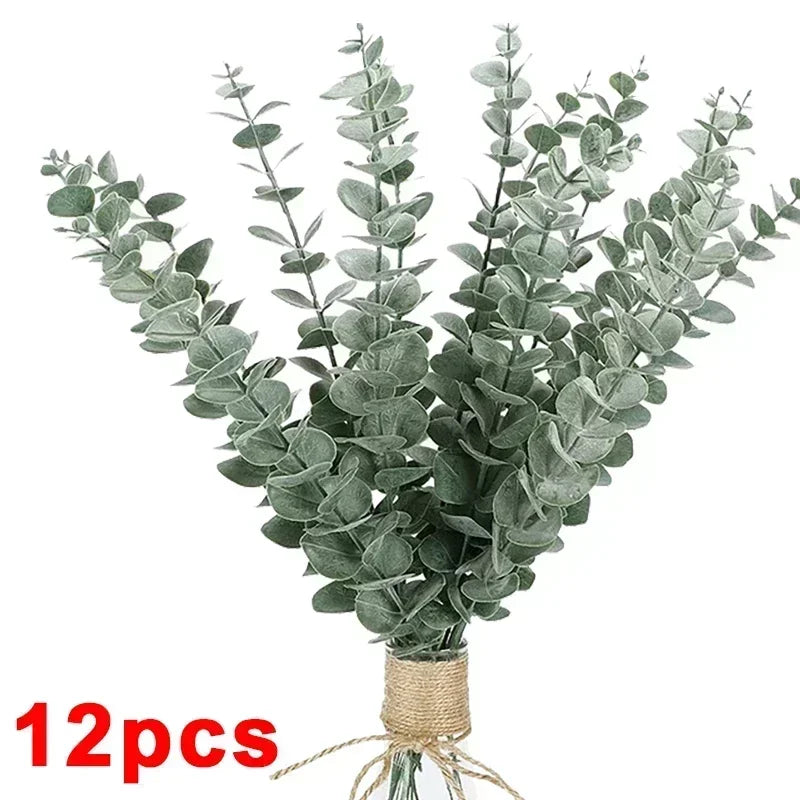 A bundle of artificial eucalyptus stems with silvery-green leaves tied together for home decor or centerpieces.
