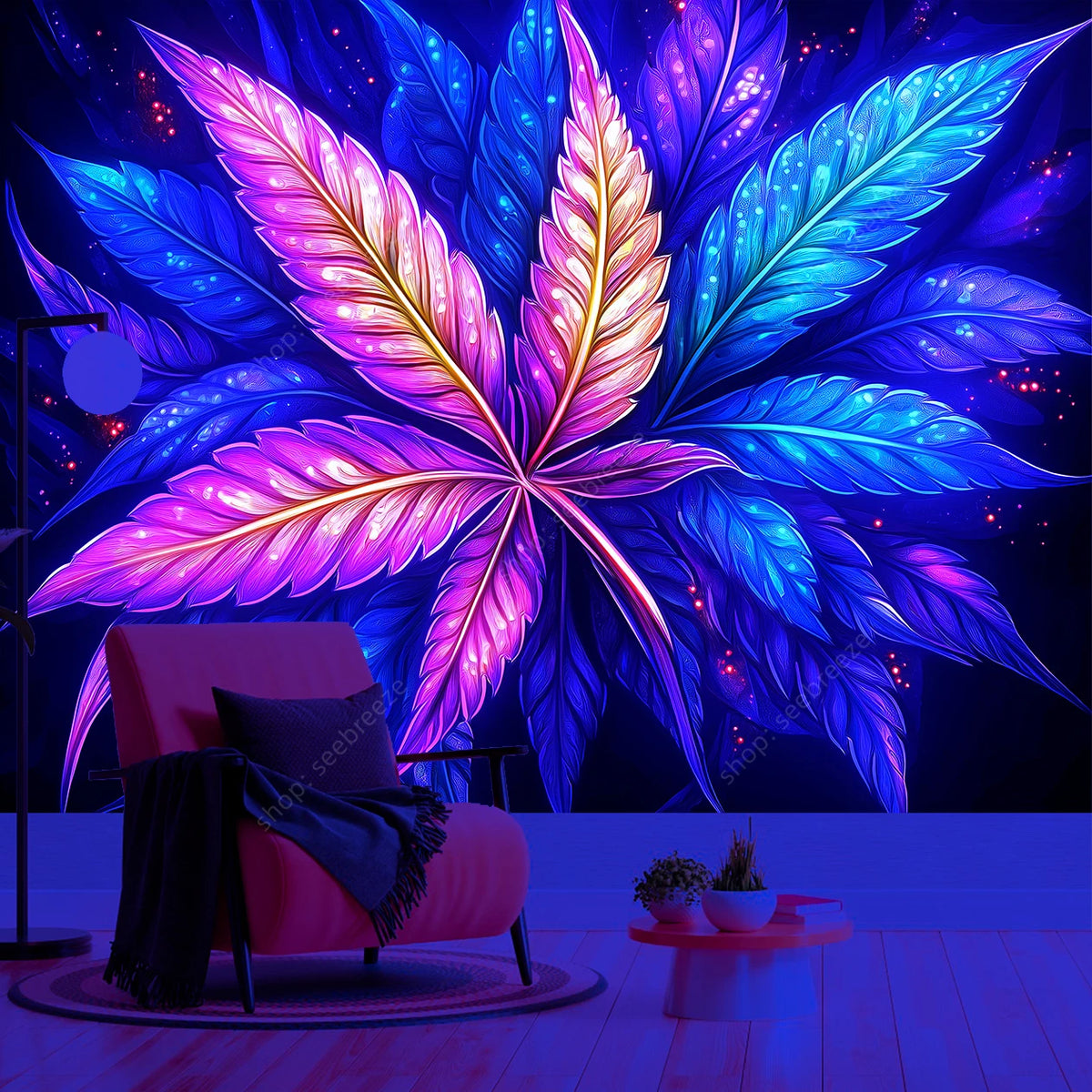 A vibrant neon cannabis leaf tapestry hangs against a dark blue background, illuminating a pink chair and wooden floor.